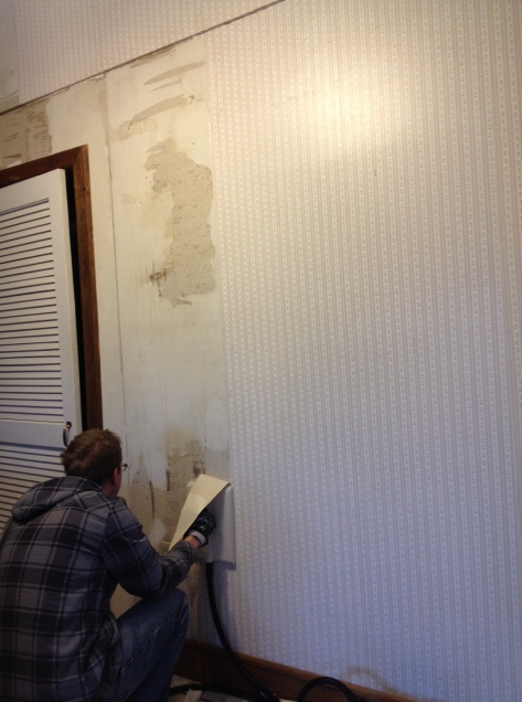 Steaming wallpaper on the kitchen wall. It was adhered to raw drywall so it's coming off a little rougher than we'd hoped. 